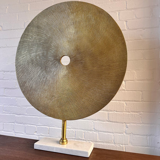 CAST METAL DISC SCULPTURE ON MARBLE BASE