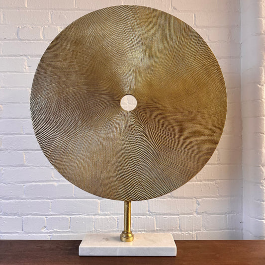CAST METAL DISC SCULPTURE ON MARBLE BASE