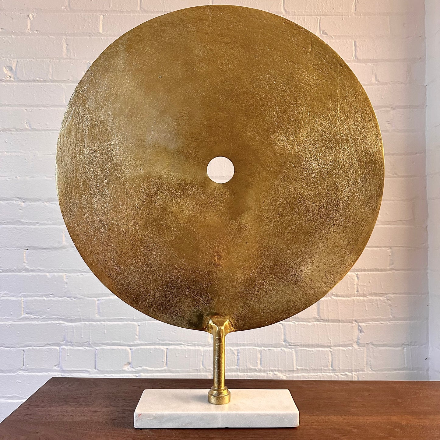 CAST METAL DISC SCULPTURE ON MARBLE BASE