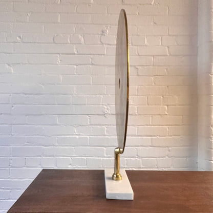 CAST METAL DISC SCULPTURE ON MARBLE BASE