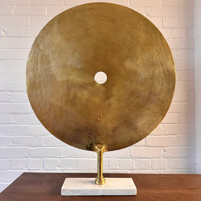 CAST METAL DISC SCULPTURE ON MARBLE BASE