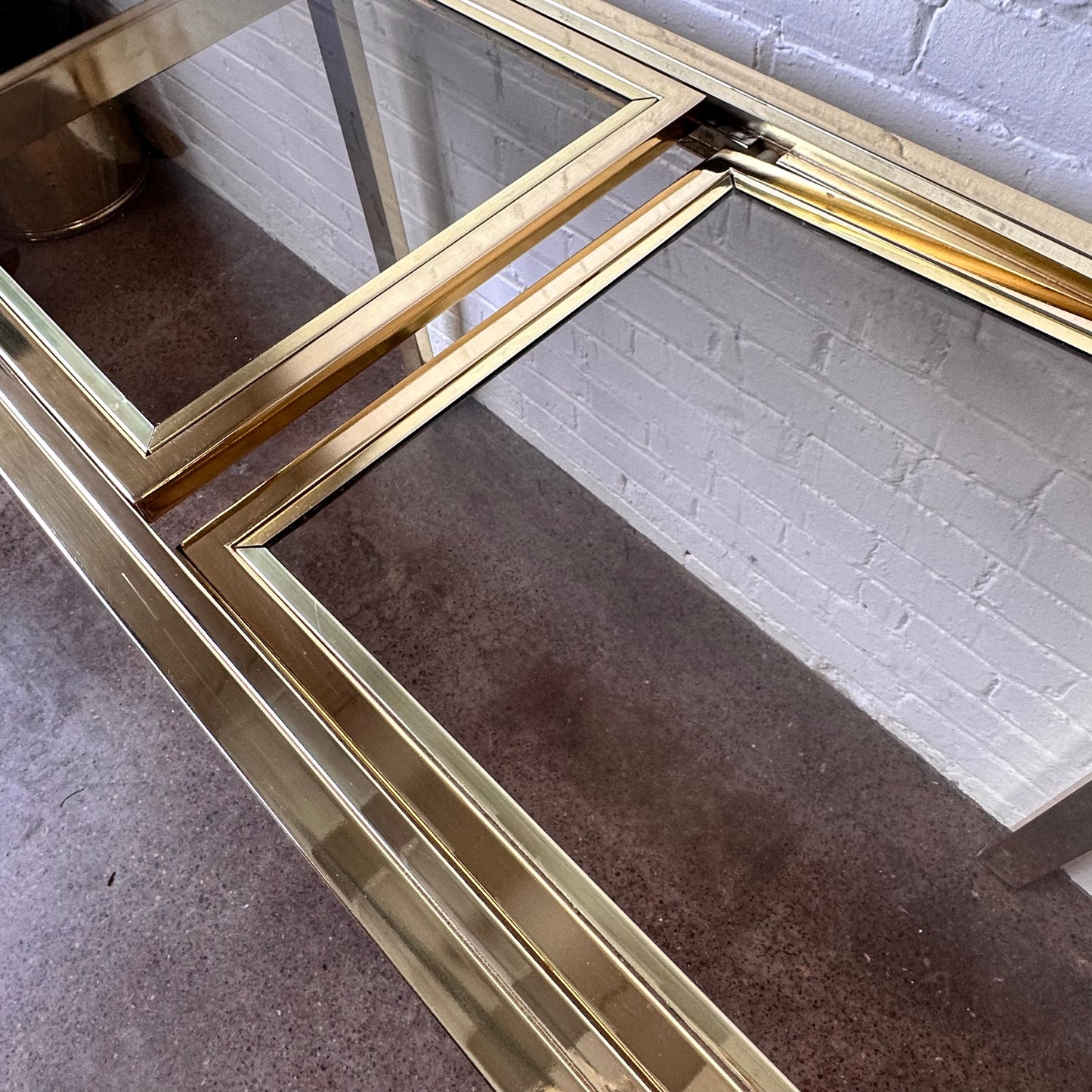 EXPANDABLE BRASS CONSOLE TABLE BY DESIGN INSTITUTE OF AMERICA