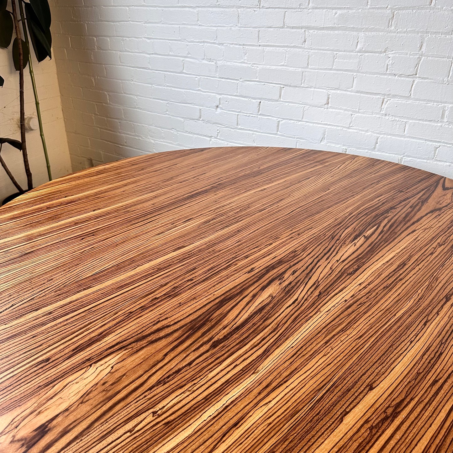 MODERN ROUND ZEBRA WOOD DINING TABLE WITH STEEL BASE